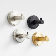 three different types of bathroom faucets on a white wall with black and gold handles