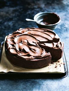 a chocolate cake is sitting on a plate