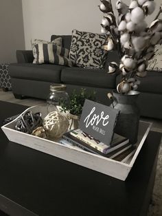 a living room with a couch, coffee table and decorative items