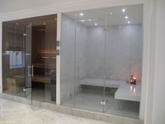 a bathroom with glass walls and a bathtub