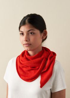 a woman wearing a red scarf and white t - shirt