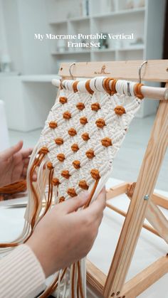 a woman is weaving on an old wooden loom with her hands and the text, my macrame portable vertical frame set