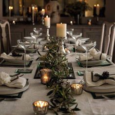 a table set with place settings and candles