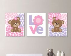 two pink and purple wall art with teddy bears