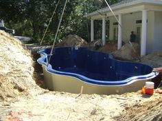 an above ground pool being built in front of a house