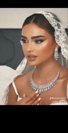 a woman wearing a wedding dress and jewelry