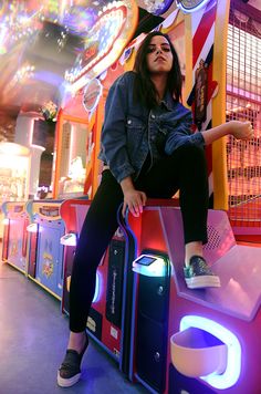 a woman sitting on top of a carnival machine