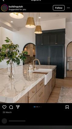 a large kitchen with marble counter tops and wooden cabinets, along with an island in the middle