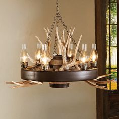 a deer antler chandelier hanging from a ceiling