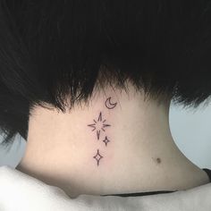 a woman's neck with three stars and a crescent tattoo