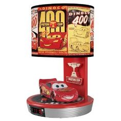 a lamp that is on top of a stand with cars around it and the number forty