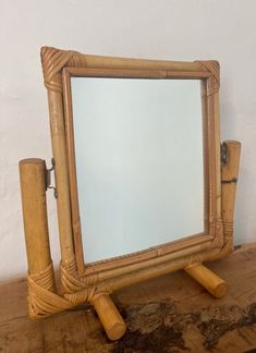 a mirror sitting on top of a wooden table