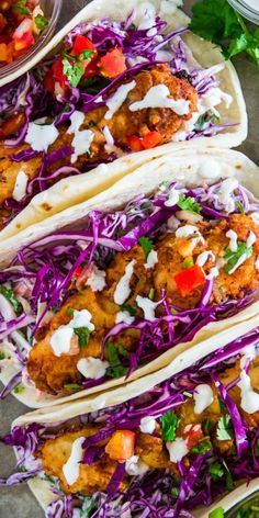 three fish tacos with cabbage slaw and cilantro