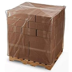 a pallet with some brown boxes wrapped in plastic on the pallets and one box is stacked high