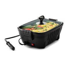 an electric cooker with food in it on a white surface and plugged into the side