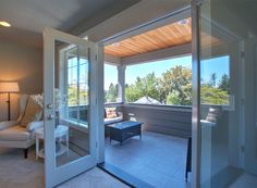 an open door leading to a living room with a large window on the other side