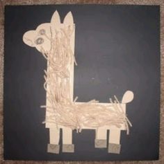 a drawing of a dog made out of sticks and paper on a blackboard background