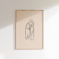 a drawing of two surfboards on a white wall above a wooden shelf with a lamp