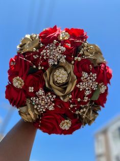 a bridal bouquet is being held up in the air