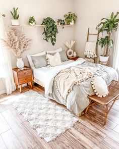 a bedroom with plants on the wall and a bed in the middle, along with two nightstands