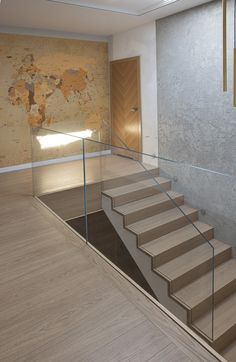 there is a set of stairs leading up to the second floor with glass railings