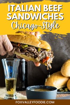 a person holding a sandwich over a glass of beer with the words italian beef sandwiches chicago style