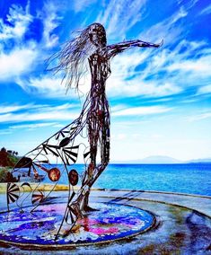 a sculpture is shown in front of the ocean