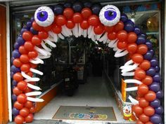 an entrance to a store decorated with balloons and fake eyeballs on the front door