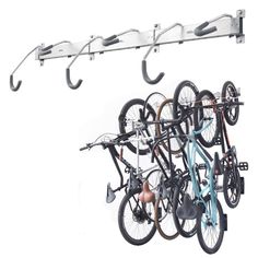 several bicycles are hanging on the wall with hooks