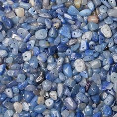 many blue and white rocks are stacked together