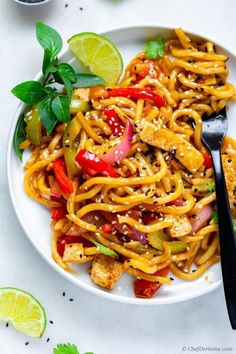 a white plate topped with noodles and vegetables