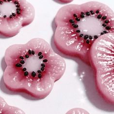 some pink flowers with black beads on them