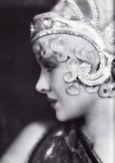 an old black and white photo of a woman wearing a tiara