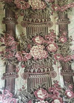 an ornate wallpaper with pink flowers on it