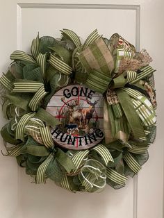 a green wreath that says gone hunting on it