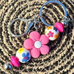 a key chain with flowers and beads on it