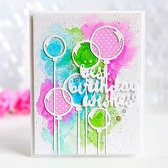 a handmade birthday card with watercolor paint splattered on it and the words, best wishes