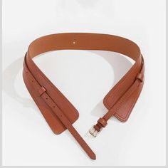 The "Hera" waistband belt is the perfect addition to your favorite outfit. offering a unique blend of vintage fashion and casual chic you won't find anywhere else. Stylish high-waisted construction and buckle-strap closure gives lasting comfort and support and ensures that you'll love the way you look and feel. Make your presence known. This is not sold in stores. and there is very limited quantity. Adjustable. Designed for style and comfort Meticulous craftsmanship Length: 100 cm - 110 cm Buckl Vintage Adjustable Belts For Spring, Trendy Adjustable Brown Belt, Trendy Fall Belt Buckles, Trendy Adjustable Belts For Fall, Adjustable Brown Belt With Self Belt Detail, Adjustable Brown Corset Belt With Matching Belt, Adjustable Brown Belt, Adjustable Brown Faux Leather Belt, Chic Adjustable Brown Belt