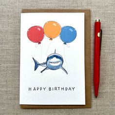 a birthday card with an image of a shark and balloons