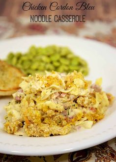 a white plate topped with an egg casserole next to green beans and bread