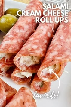 some food is laying out on a white plate and has the words salami cream cheese roll ups