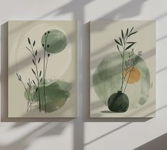 two paintings with green and yellow designs on the wall next to each other in front of a white wall