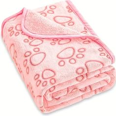 a pink blanket with paw prints on it