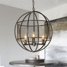 a chandelier hanging from the ceiling in a dining room