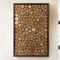 a wooden panel with circles and holes on the side of it, mounted to a wall