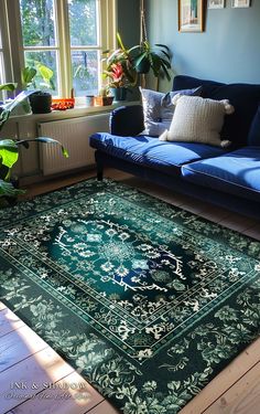 a living room with blue couches and green rug