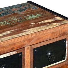 an old wooden table with two drawers and metal knobs on the bottom, painted green