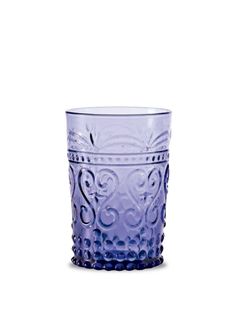 a purple glass cup sitting on top of a white table