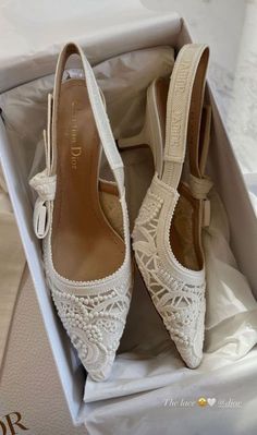 white wedding shoes with lace and bows in a box