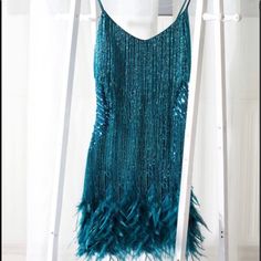 New Showstopper Sequins Feather Spaghetti Strap Mini Dress The Ultimate Show-Stopping Party Dress! Individually Hand Embellished With Teal Crystal Waterfall Beading To Create A Mesmerising Illusion When Worn. Adorned In Teal Beaded Fringing And Sequins With Flat Beaded Panelling On The Waist To Accentuate Your Curves And Flatter Your Figure. Detailed With High Shine Sequin, Fall-Proof Tassels All Along The Fringes From The Front To The Back. The Mini Dress Is Topped With A Feather Hem Around The Beaded Panelling, Spring Mini Dresses, Ascot Dresses, Sara Dress, Adele Dress, Cocktail Gowns, Spaghetti Strap Mini Dress, Faux Leather Dress, Striped Mini Dress